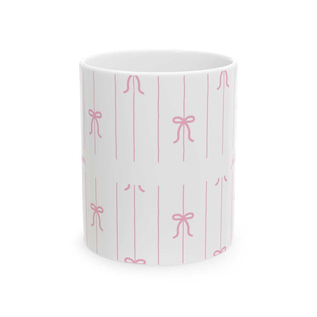 Personalized pink bow pattern mug displayed on a desk