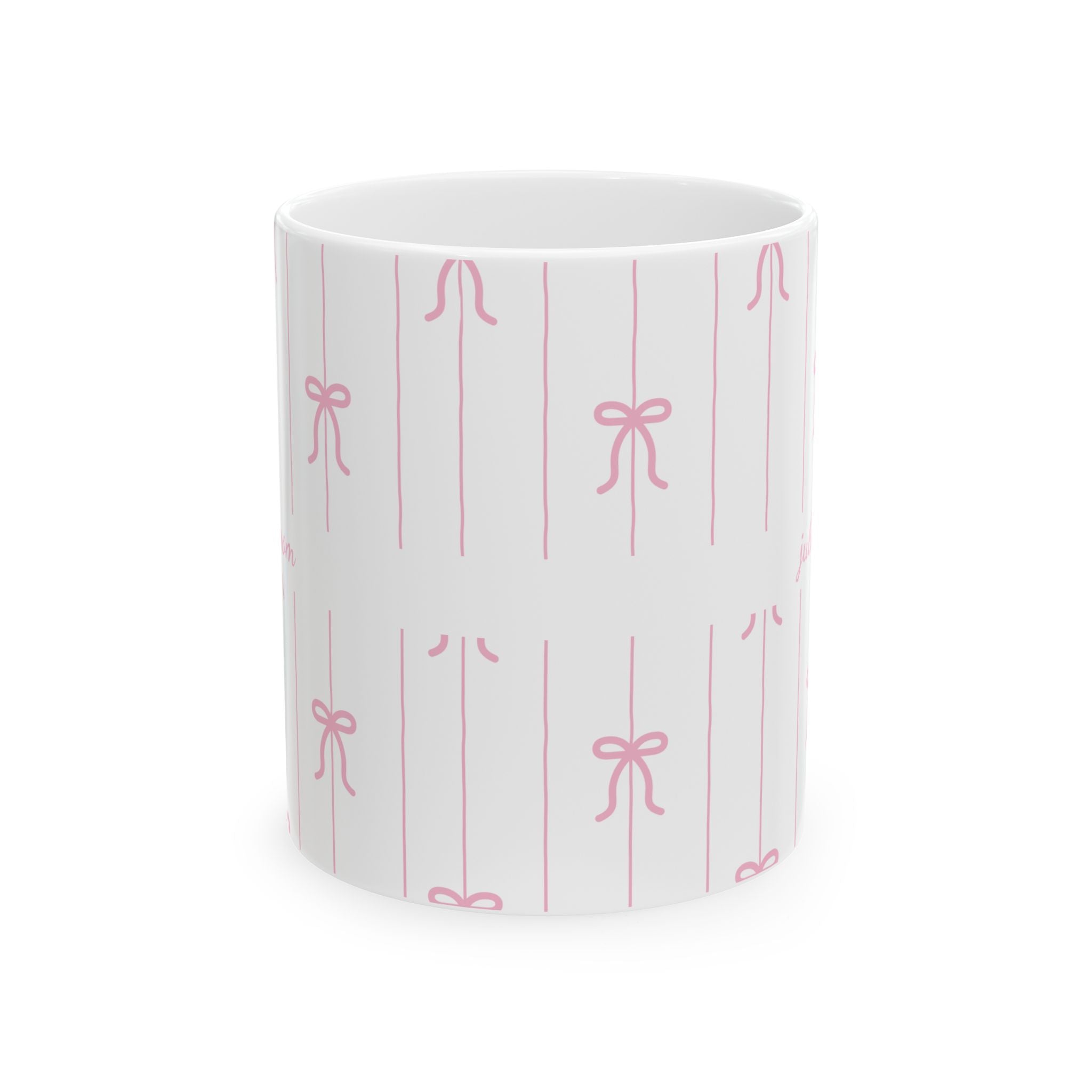 Personalized pink bow pattern mug displayed on a desk