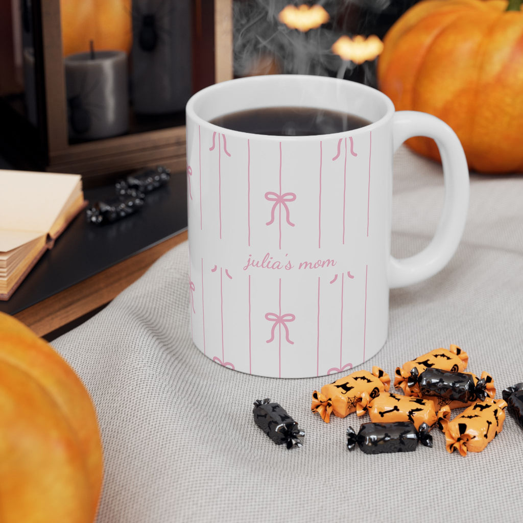 Personalized pink bow pattern mug shown on a table as a birthday gift
